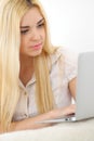 Happy woman doing online shopping at home . Close- up of a hand holding a credit card next to a laptop Royalty Free Stock Photo