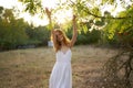 happy woman in a dress on nature near green leaves trees and bushes in the background Royalty Free Stock Photo