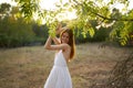 happy woman in a dress on nature near green leaves trees and bushes in the background Royalty Free Stock Photo