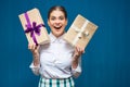Happy woman dressed white shirt holding two gift boxes Royalty Free Stock Photo