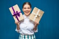 Happy woman dressed white shirt holding two gift boxes Royalty Free Stock Photo