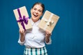 Happy woman dressed white shirt holding two gift boxes Royalty Free Stock Photo