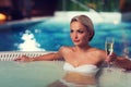 Happy woman drinking champagne at swimming pool Royalty Free Stock Photo