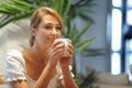 Happy woman drinking coffee at home looking away Royalty Free Stock Photo