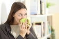 Happy woman drinking coffee looks away standing at home Royalty Free Stock Photo