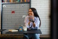 Happy woman drinking coffee in the morning at restaurant Royalty Free Stock Photo