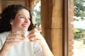 Happy woman drinking coffee in a restaurant looks away Royalty Free Stock Photo