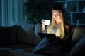 Happy woman drinking coffee and using tablet in the night Royalty Free Stock Photo