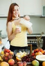 Happy woman drinking milk cocktail with fruits Royalty Free Stock Photo