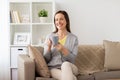 Happy woman drinking tea or coffee at home Royalty Free Stock Photo
