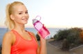 Happy woman drinking water from bottle outdoors Royalty Free Stock Photo