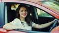 Happy woman driver behind a wheel red car Royalty Free Stock Photo