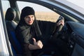 Happy woman driver smiling while driving showing thumb up