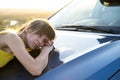 Happy woman driver in summer dress enjoying warm evening near her car. Travel and vacation concept Royalty Free Stock Photo