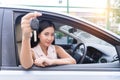 Happy woman driving car hand holding key looking at camera focus on face. Royalty Free Stock Photo