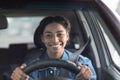 Happy woman driving car and smiling going to work or on road trip Royalty Free Stock Photo