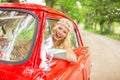 Happy woman driving a retro car