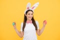 Happy woman in easter bunny ears. Funny face. Girl rabbit studio isolated portrait. Easter eggs.