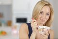 happy woman eating cereals