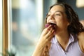 Woman eating chocolate cupcake in a restaurant Royalty Free Stock Photo