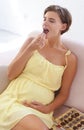 Happy woman, eating chocolate and pregnant in home, alone and enjoying delicious pregnancy craving. Good mood, comfort Royalty Free Stock Photo