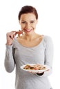 Happy woman eating christmas cookies