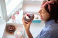 Happy woman eating delicious donuts Royalty Free Stock Photo