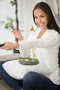 happy woman eating fresh vegetable salad while watching tv Royalty Free Stock Photo