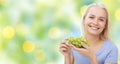 Happy woman eating grapes
