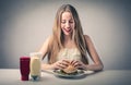 Happy woman eating a hamburger