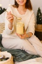 Happy Woman Eating Peanut Butter on a Spoon Royalty Free Stock Photo