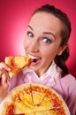 Happy woman eating piece of pizza