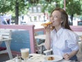Happy woman eating pizza in summer cafe. Royalty Free Stock Photo