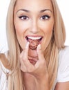 Happy woman eating praline