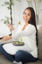 happy woman eating salad while watching tv Royalty Free Stock Photo