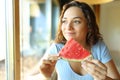 Happy woman eating watermelon in a restaurant Royalty Free Stock Photo