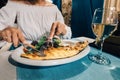 Woman eats grilled sea bass fish in a Mediterranean restaurant Royalty Free Stock Photo