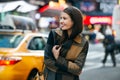 Happy woman enjoy the walk on winter time on New York City street and doing Christmas shopping. Royalty Free Stock Photo