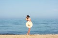 Happy woman enjoying beach relaxing joyful in summer by blue water. Royalty Free Stock Photo