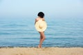 Happy woman enjoying beach relaxing joyful in summer by blue water. Royalty Free Stock Photo