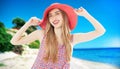 Happy woman enjoying beach relaxing joyful in summer by tropical blue water and beach. Beautiful model happy on travel wearing Royalty Free Stock Photo