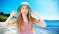 Happy woman enjoying beach relaxing joyful in summer by tropical blue water and beach. Beautiful model happy on travel wearing Royalty Free Stock Photo