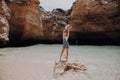 Happy woman enjoying at the rock beach. Summer vacations concept Royalty Free Stock Photo