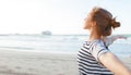 Happy woman enjoying freedom with open hands on sea Royalty Free Stock Photo