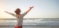 Happy woman enjoying freedom with open hands on sea Royalty Free Stock Photo