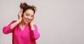 Happy woman enjoying music in headphones over background Royalty Free Stock Photo