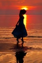 Happy Woman enjoying in Sea Sunset. Silhouetted against the suns Royalty Free Stock Photo