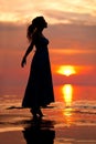 Happy Woman enjoying in Sea Sunset. Silhouetted against the suns Royalty Free Stock Photo