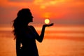 Happy Woman enjoying in Sea Sunset. Silhouetted against the suns Royalty Free Stock Photo