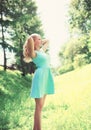 Happy woman enjoys sunny day in forest